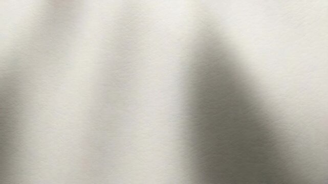 Smooth textured surface gradually shifting in light showcasing soft shadows and subtle changes in color creating an abstract visual experience in a minimalistic environment