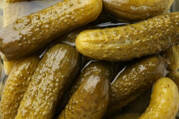 Pickled cucumbers in brine as background, closeup