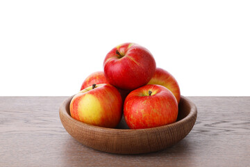 Ripe red apples in bowl on wooden table against white background, closeup