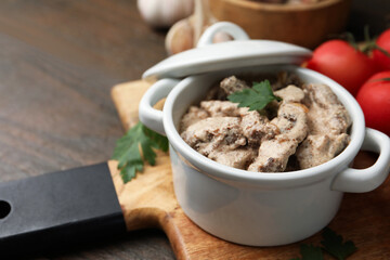 Tasty beef stroganoff with parsley served on wooden table, closeup. Space for text