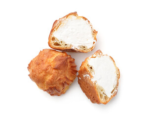 Tasty profiteroles with whipped cream isolated on white