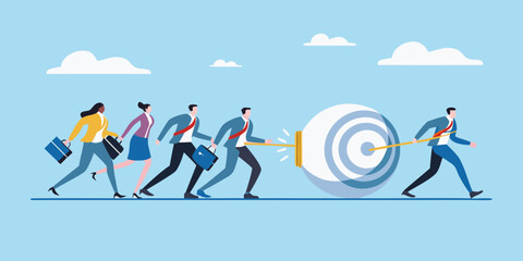 Business team pushing a large target towards a goal