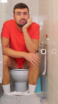 Frustrated looking man in the bathroom 