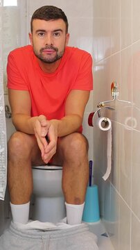 Comedic video of a man having discomfort in the toilet 