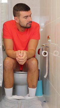 Frustrated looking man in the bathroom 