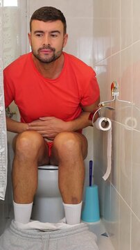 Comedic video of a man having discomfort in the toilet 