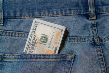 Cash Tucked in Denim Pocket During a Sunny Day, Reflecting Everyday Transactions in Urban Life