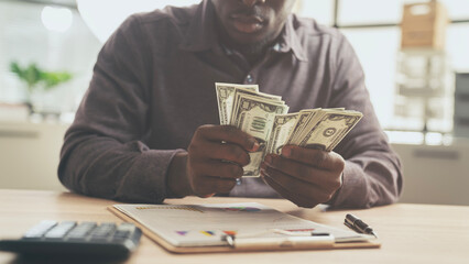 Businessman hands holding and counting dollars