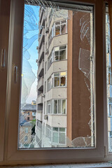 KYIV, UKRAINE - JUNE 6, 2025: Damage to the balcony of a residential building after a drone strike, showing broken windows and debris on the wall.