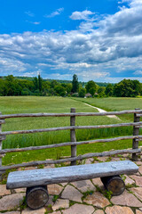 Green summer colors light up the countryside among old wooden houses and ancient churches in Ukraine, creating a warm nostalgic atmosphere.
