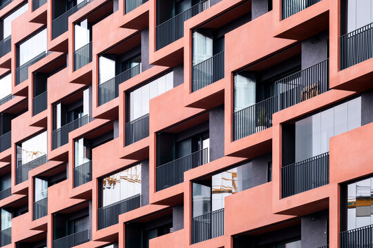 A modern architecture scene featuring facade repetition with pattern geometry as background hues and contrast define a strong structure influenced by abstract design and urban texture