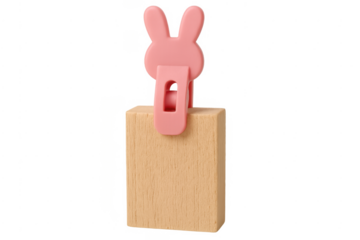 Pink bunny clip holding wooden block on transparent background