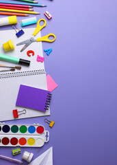 Fototapeta premium Vertical photo format. Back to School Supplies and Stationery on a Vibrant Background for a Fresh Start
