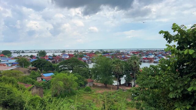 Viewpoint of a flooded fishing village near the Krahom Temple, Cambodia. From the mountain Krahom (Pnom Krom) overlooking the lake Tonlesap. Houses are built on high stilts. Rainy season. 4К