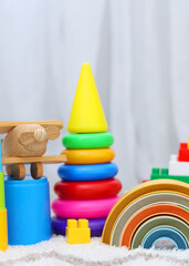 A vibrant display of childrens toys on a bright yellow backdrop, perfect for playful themes and joyful imagination. Vertical photo format