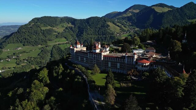 Aerial drone footage of SHMS Swiss Hotel Management School campus in Montreux, Switzerland, showcasing modern architecture, scenic Lake Geneva, and surrounding mountains