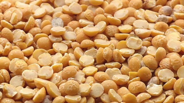 Dry yellow split peas background texture close-up