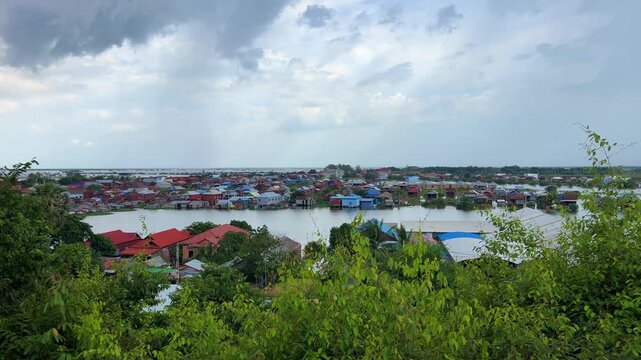 Viewpoint of a flooded fishing village near the Krahom Temple, Cambodia. From the mountain Krahom (Pnom Krom) overlooking the lake Tonlesap. Houses are built on high stilts. Rainy season. 4К