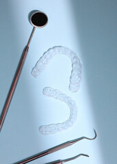 Aligners for straightening teeth on a light background. Vertical photo format