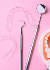 Aligners for straightening teeth on a light background. Vertical photo format