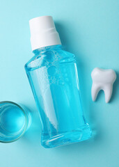A mouthwash on a colored background. Dental care, dental health. Vertical photo format
