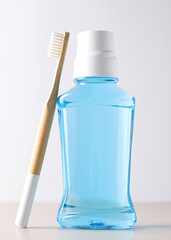 A mouthwash on a colored background. Dental care, dental health. Vertical photo format