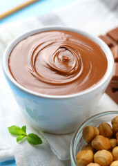 chocolate paste with a bowl on a table.  Vertical photo format