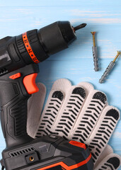 Vertical photo format. Cordless Drill Featuring Various Drill Bits Set Against a Vibrant Blue Background