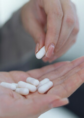 Vertical photo format. Taking Medication An InDepth Close Up View of Various Pills and Water for Hydration