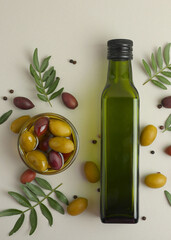 Vertical photo format. A premium olive oil with olives and fresh leaves, top view 
