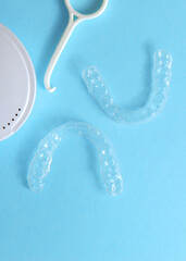 Vertical photo format.Aligners for straightening teeth on a blue background