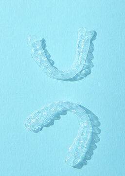 Vertical photo format.Aligners for straightening teeth on a blue background