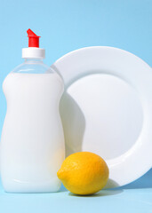 Vertical photo format.Dishwashing detergent and lemons on a light background