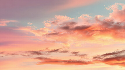 Obraz premium A stunning, picturesque skyscape filled with vibrant colors of sunset, painting the clouds with hues of pink, orange, and purple, creating a breathtaking vista.