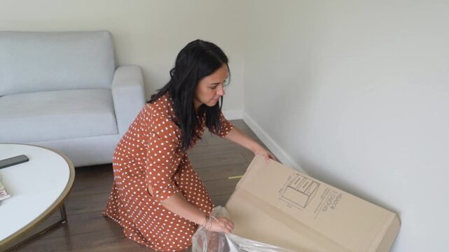 Woman Unpacking Flat-Pack Table in Living Room
