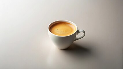 Obraz premium A single serving of dark roasted espresso in a minimalist white cup, a simple image perfect for showcasing coffee products or for use as a background image for publications or websites.
