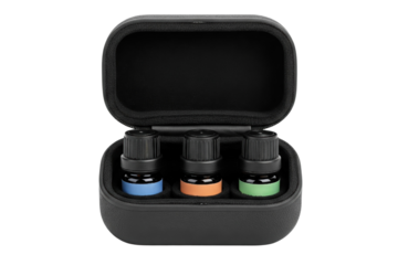 Open black travel case holding three glass dropper bottles isolated on a transparent background