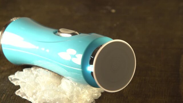 Portable stone attachment rotates on a grinder. Sandpaper is spinning video with sound.