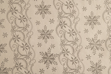 Snowflake and floral stripe pattern on kraft paper
