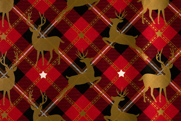 Cotton fabric Festive reindeer pattern on red and black plaid background
