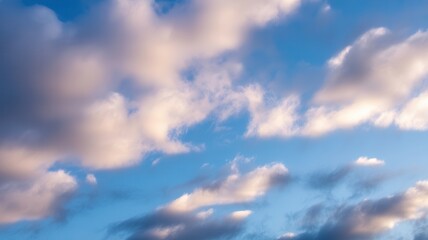Softly lit clouds in a blue sky during golden hour or sunset