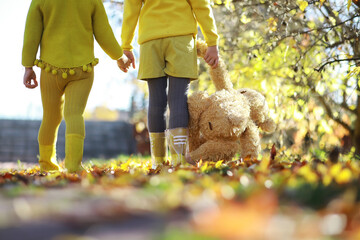 Obraz premium Children Having Fun And Balancing On Tree In Fall Woodland
