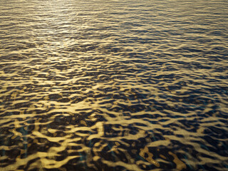 Soft blue ocean water with bright reflections in calm weather