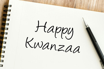 A heartfelt handwritten message wishing a joyful Kwanzaa celebration displayed on a notepad, perfect for festive greetings