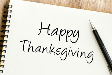 A heartfelt Happy Thanksgiving message penned on a spiral-bound notebook, ready for sharing warmth and gratitude during the autumn holiday season