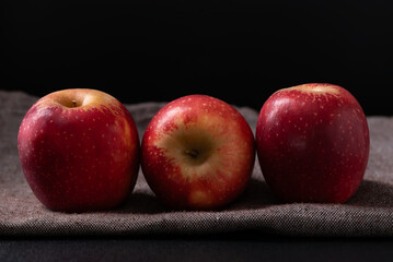 Red apple fruit on fabric with black background