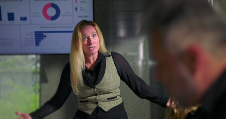 Female boss snapping man out of deep thought with loud reprimand during tense office meeting, assertive leadership and sudden confrontation in corporate environment