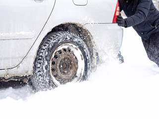 Car stuck in deep snow winter road transportation problem wheel spinning trapped vehicle emergency blizzard travel delay cold weather breakdown assistance needed stranded driver frustration tires 