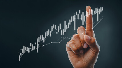Finger pointing at digital chart trading financial growth.