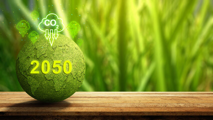 Green globe resembling Earth, with a focus on environmental issues and the reduction of CO2 emissions by the year 2050. Concept of Net Zero Emission